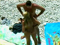 The nudist couple behaved nastily on the beach and was caught by the guy with camera