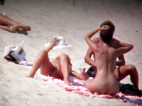 The nudist woman is lying in the sun and her natural body is covered with nothing but the big white hat. Enjoy the view!